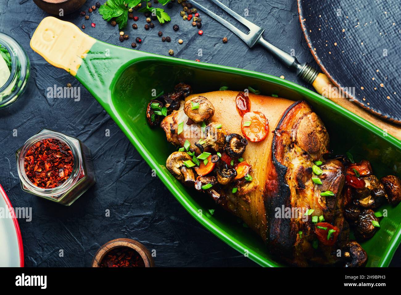 Delicious roast pork knuckle in the baking dish. Pork hock, German cuisine Stock Photo