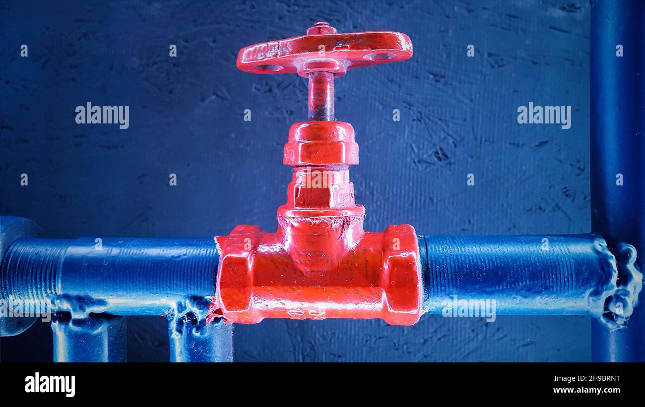 Red Shut Off Water shut-off red valve on a blue metal pipe Stock Photo - Alamy