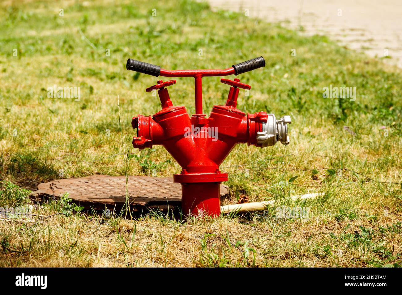 A red fire hydrant is installed in the hatch Stock Photo Alamy