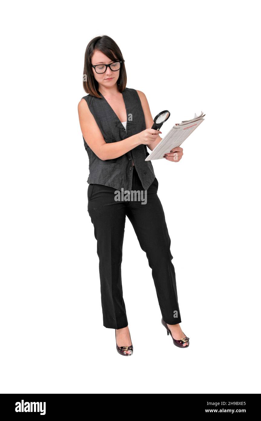 young business woman reads the stock quotes with magnefying glass Stock Photo