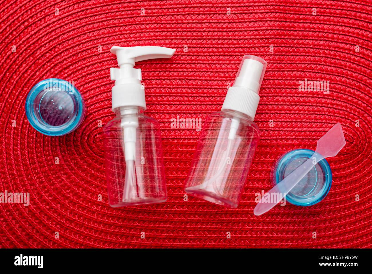 Set of plastic containers, containers for air travel on a red