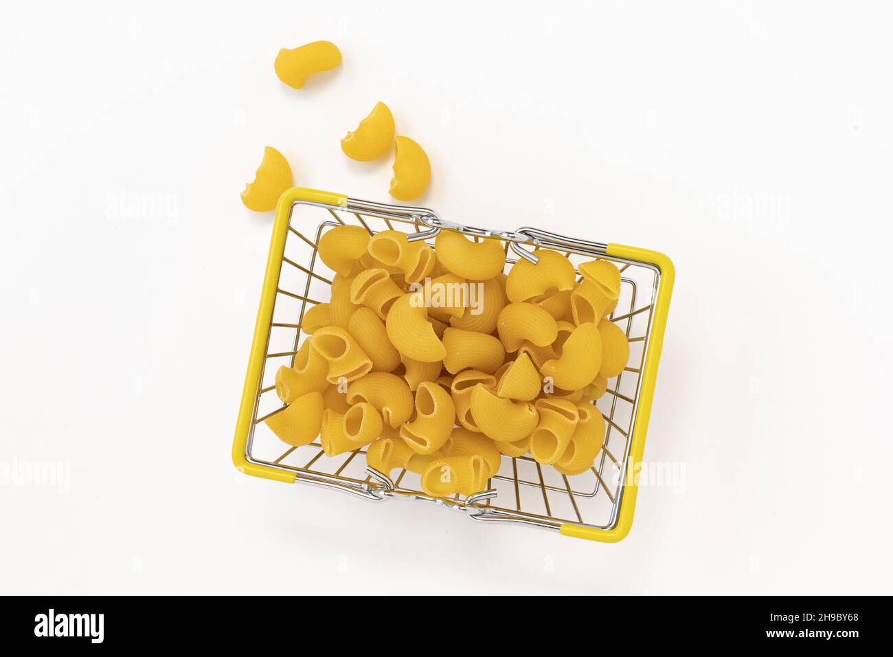 italian pasta in grocery basket from market on white background, flour products and food in cooking Stock Photo