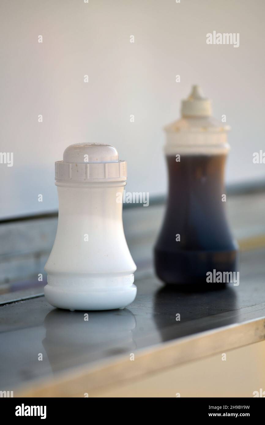 salt and vinegar in fish and chip shop Stock Photo