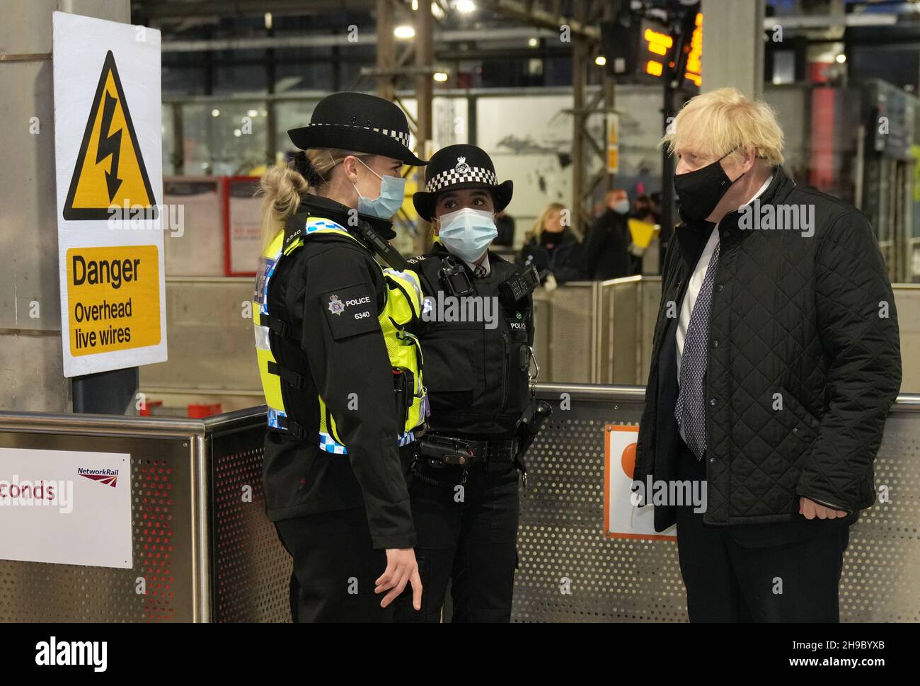 British Prime Minister Boris Johnson talks to British Transport Police officers at Liverpool Lime Street station as part of 'Operation Toxic' to infiltrate County Lines drug dealings, ahead of the publication of the government's 10-year drug strategy. Picture date: Monday December 6, 2021. Stock Photo