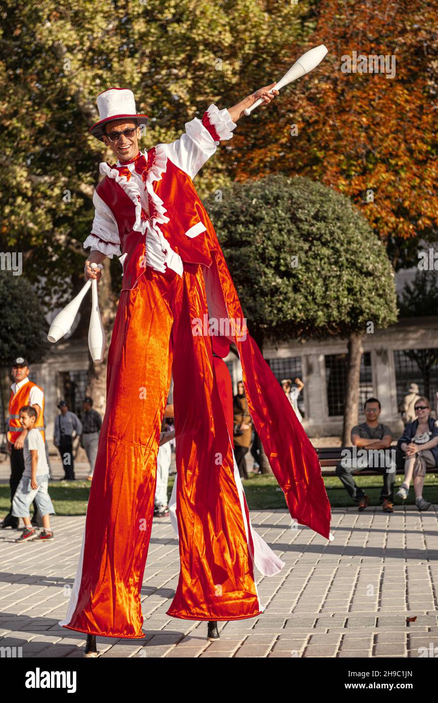 Istanbul, Turkey, SEPTEMBER 28 2012: It is a entertainment festival in a street of Istanbul stilts walker man in red juggling smiling Stock Photo