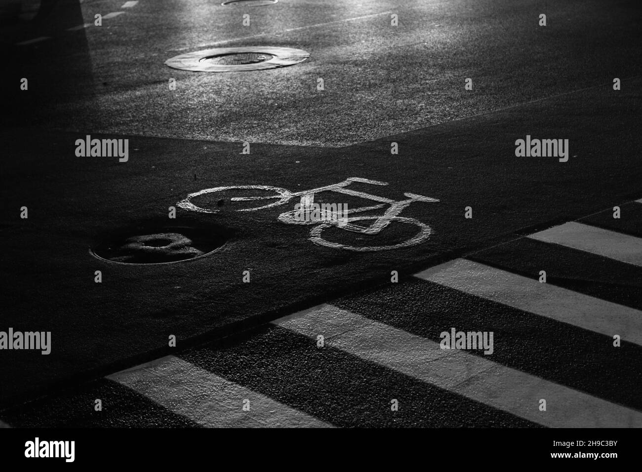 Greyscale shot of a bicycle sign on the asphalt Stock Photo