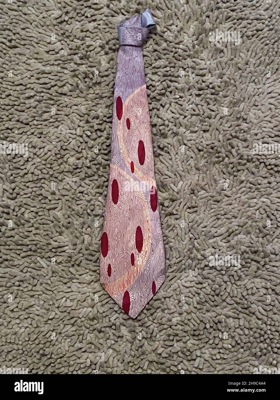 A burgundy and gray Art Deco necktie with a beautiful period design. Likely from the 1940s or possibly the 1930's. Stock Photo
