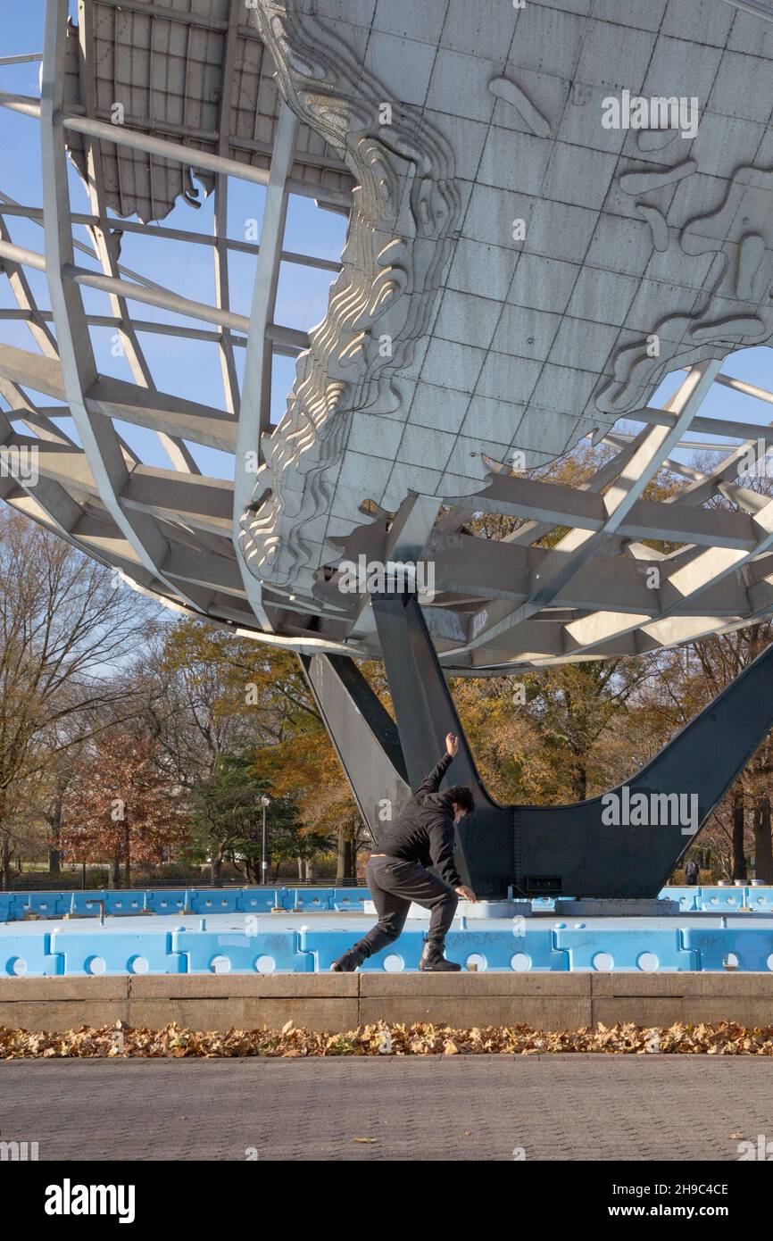 A young roller skater practices stunts by skating on a thin wall around