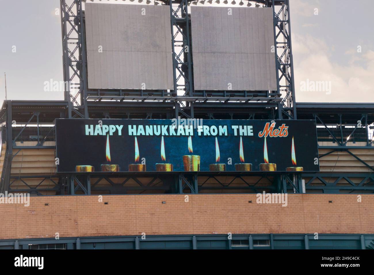 A sign on top of the exterior of Citi Field wishes fans - especially Jewish fans - a Happy Hanukkah. In Flushing, Queens, New York City. Stock Photo