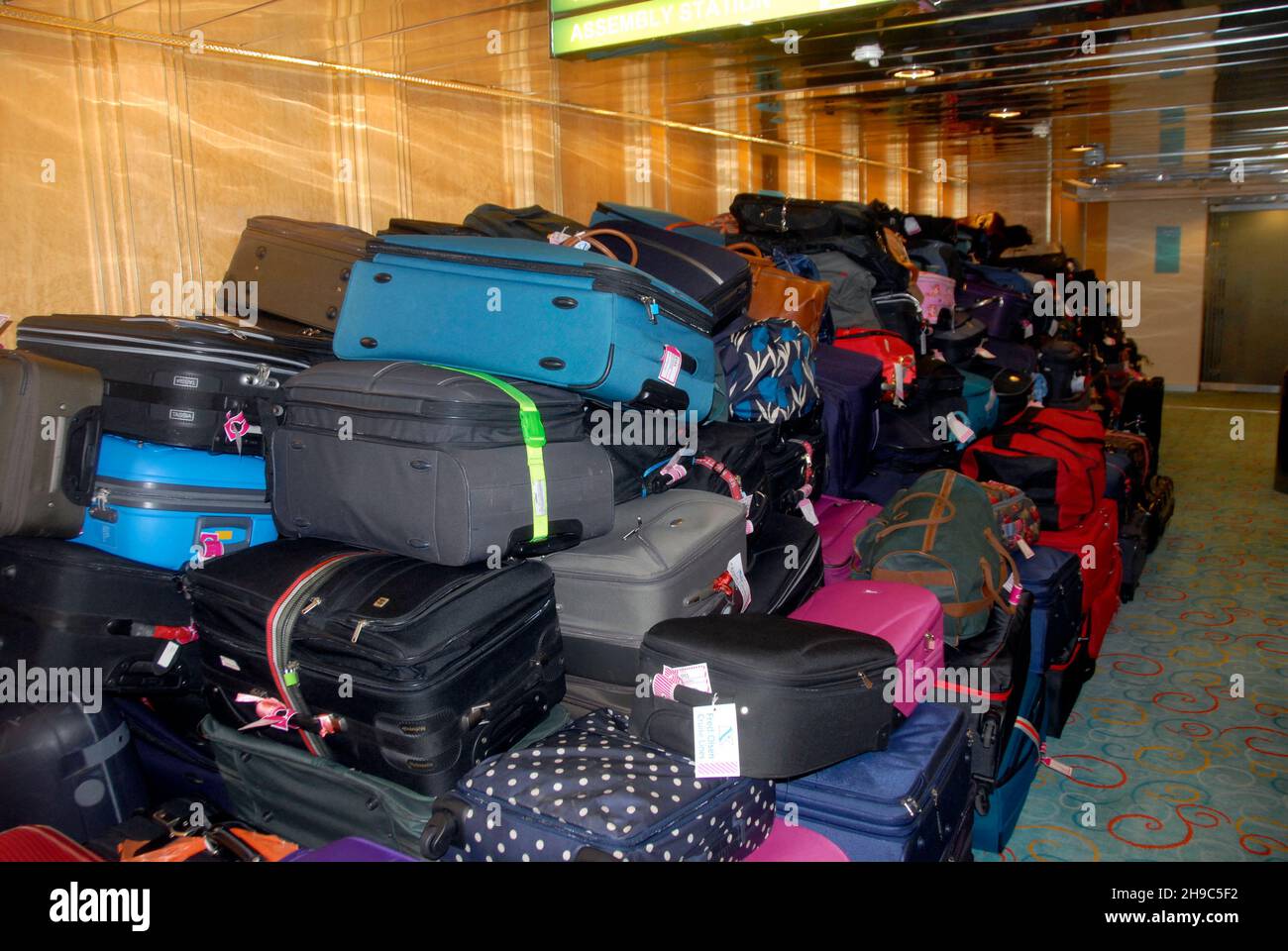 Luggage collected by porters from passengers on a cruise ship and placed in a temporary holding area before disembarking Stock Photo