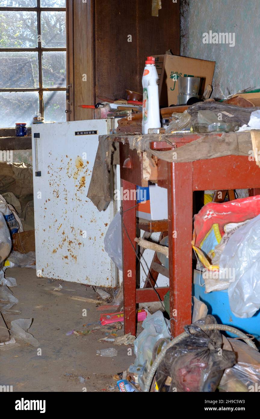 filthy dirty untidy cluttered interior anteroom of a deceased hoarder zala county hungary Stock Photo