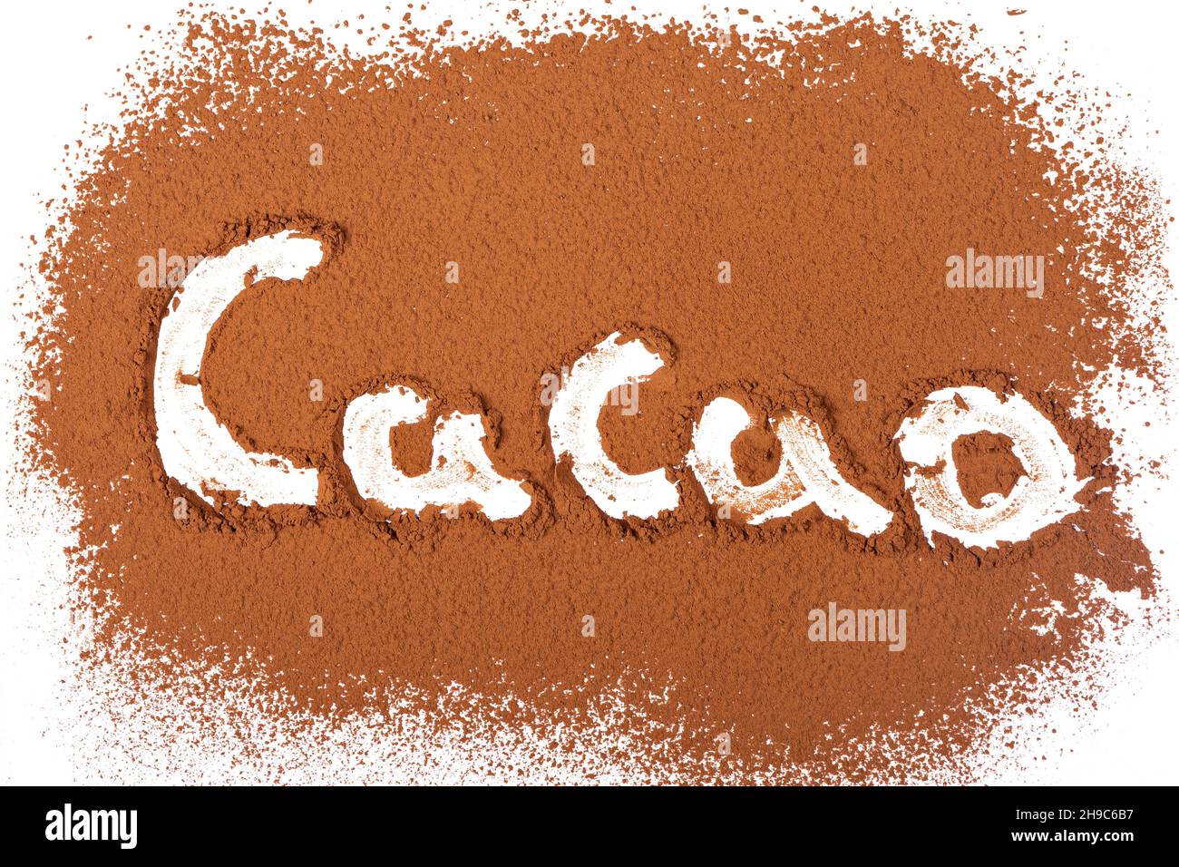 Studio photo with white background of handmade engraved letters on cocoa powder surface Stock Photo