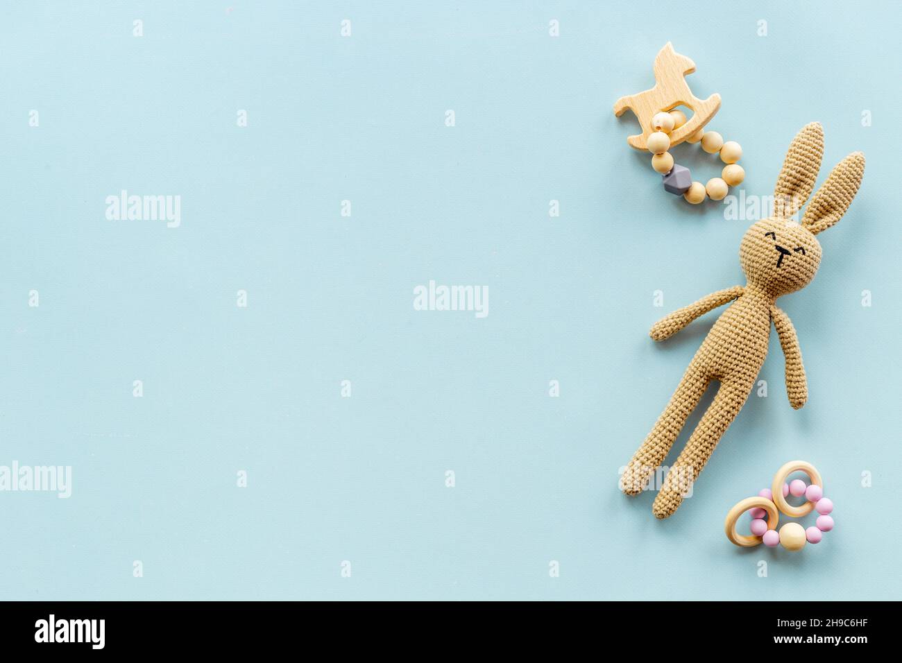 Knitted baby toy rabbit for newborn with wooden toys, top view Stock ...