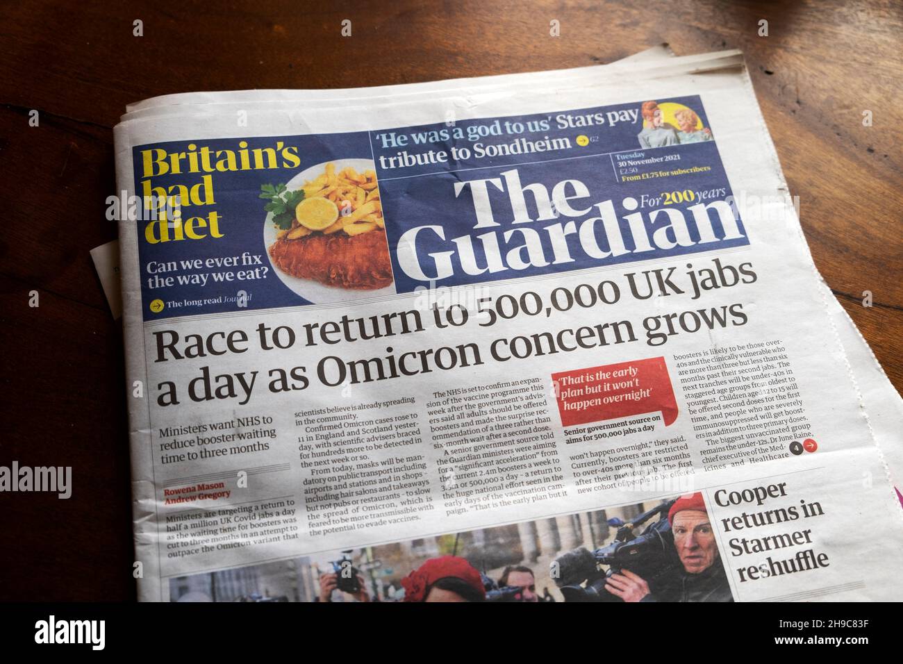 Guardian newspaper front page covid headline 'Race to return to 500,000 UK jabs a day as Omicron concern grows' 30 November 2021 London UK Britain Stock Photo