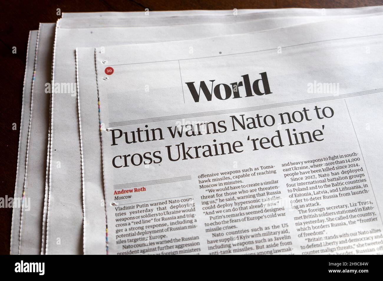 'Putin warns Nato not to cross Ukraine 'red line'' Guardian newspaper headline article clipping London England UK Stock Photo