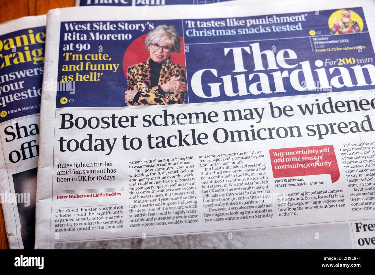 "Booster scheme may be widened today to tackle Omicron spread" Guardian newspaper headline Omicron covid on front page 29 November 2021 in London UK Stock Photo