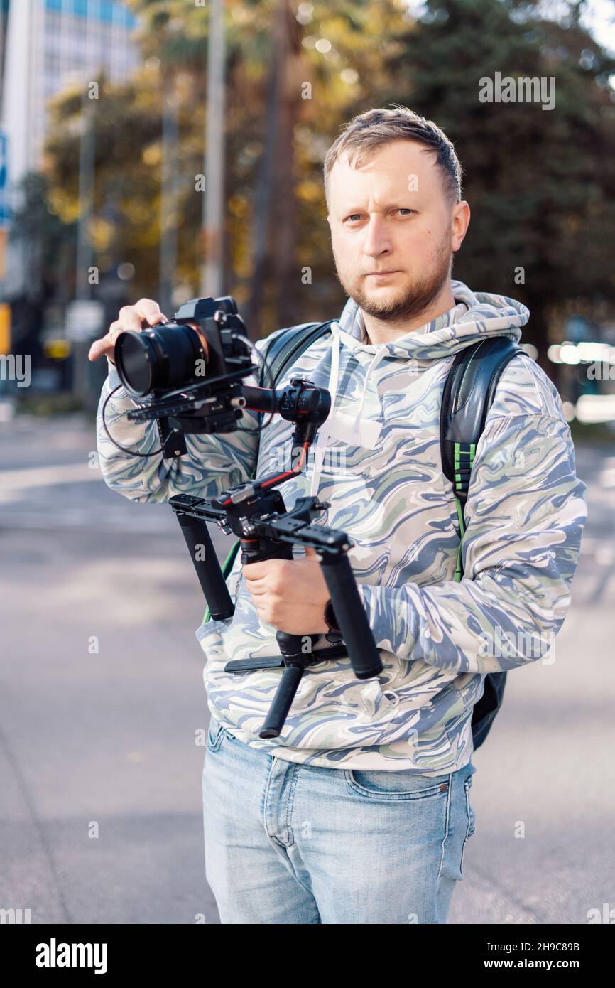 Professional videographer with gimball equipment setup before shooting. He is ready for video work Stock Photo