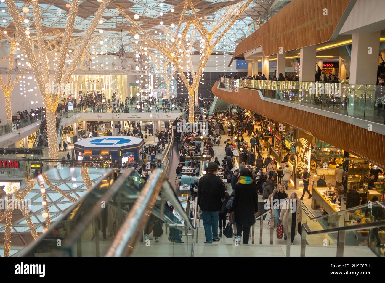 LONDON- December 2021:  Shoppers inside Westfield London- large shopping centre in Shepherds Bush Stock Photo