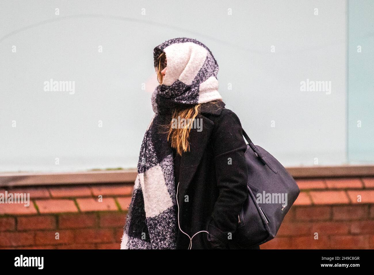Preston, Lancashire.   Uk Weather 6 Dec 2021. Shops, shoppers, shopping in the city centre on a wet and windy day. A weather warning for 50mph winds is set to come into force as Storm Barra approaches.  Credit: MediaWorldImages/AlamyLiveNews Stock Photo