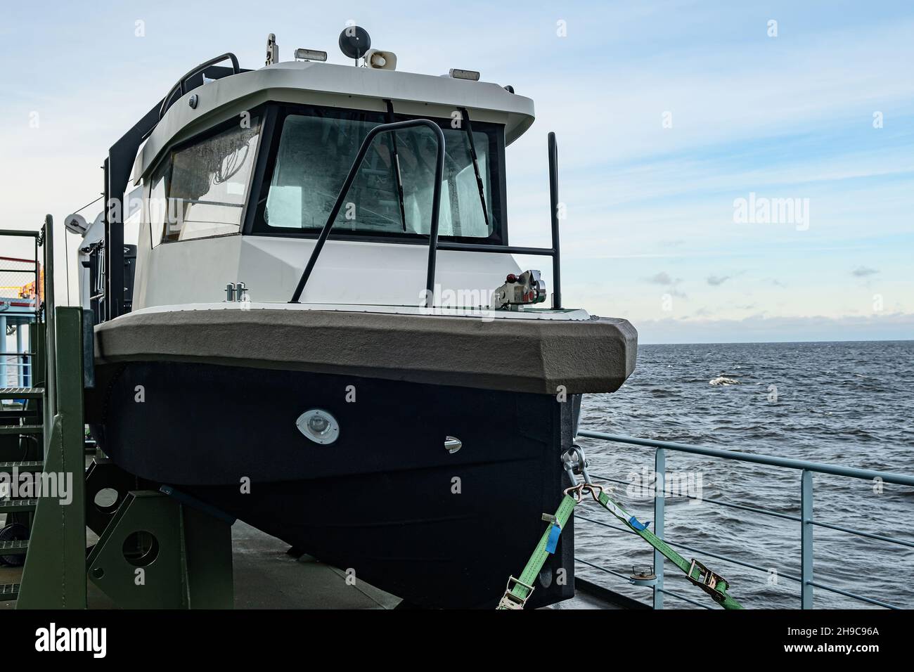 The boat is mounted on a mounting bracket, secured with safety belts