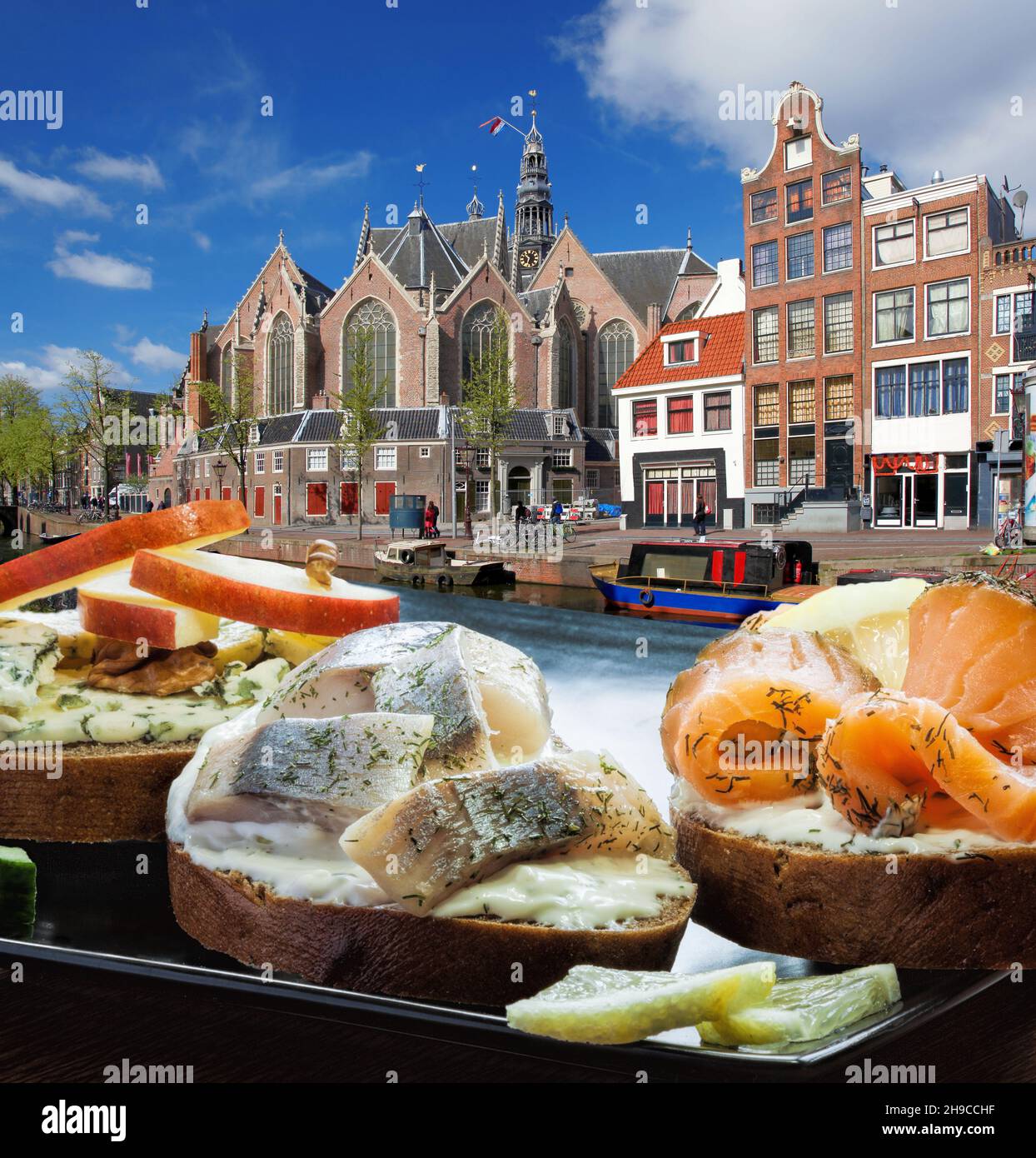 Amsterdam city with fishplate (salomon and codfish sandwiches) against  tourboat on canal in Netherlands Stock Photo - Alamy