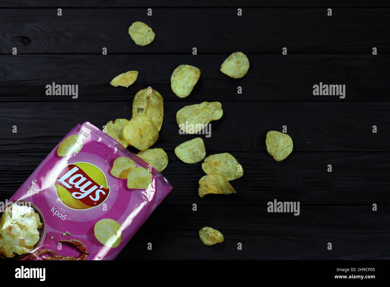 KHARKOV, UKRAINE - JANUARY 3, 2021: Lays potato chips with crab flavour and original lays logo in middle of package. Worldwide famous brand of potato Stock Photo