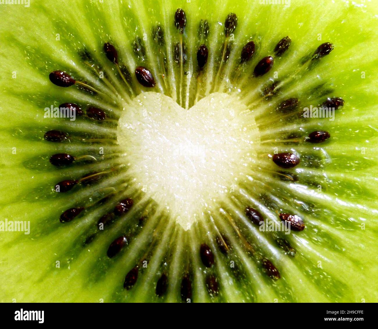 Closeup of kiwi fruit with heart shape in the middle Stock Photo
