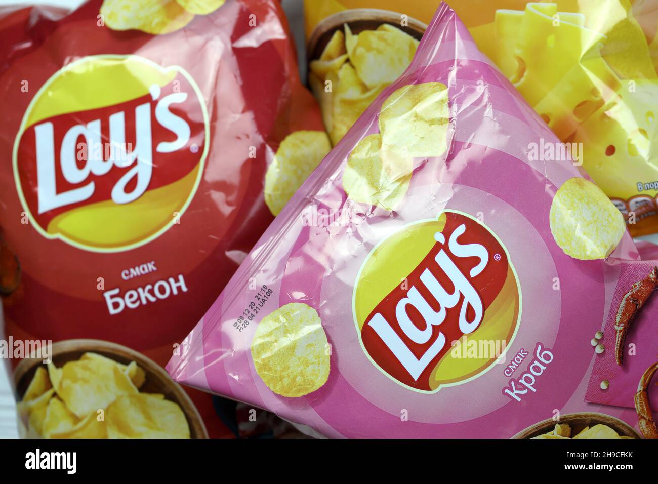 KHARKOV, UKRAINE JANUARY 3, 2021 Various flavoured of lay's potato chips on wooden background