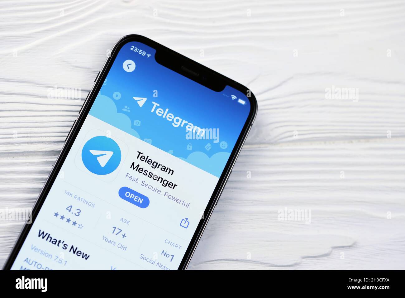 KHARKOV, UKRAINE - MARCH 5, 2021: Telegram Messenger icon and application from App store on iPhone 12 pro display screen on white wooden table Stock Photo