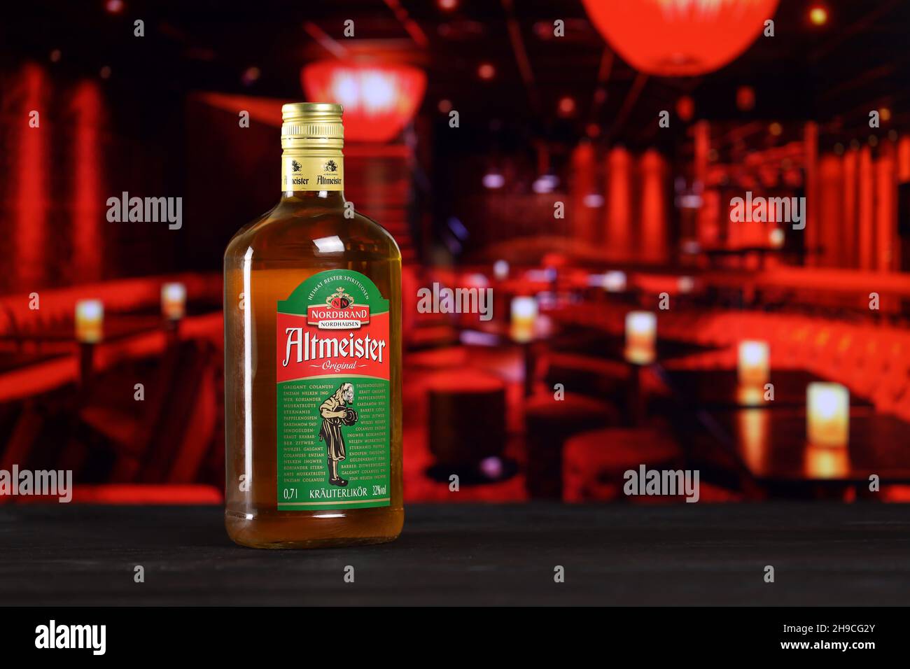 KHARKOV, UKRAINE - FEBRUARY 14, 2021: Altmeister original liqueur bottle on wooden table with red bar interior on background. Elite alcohol production Stock Photo