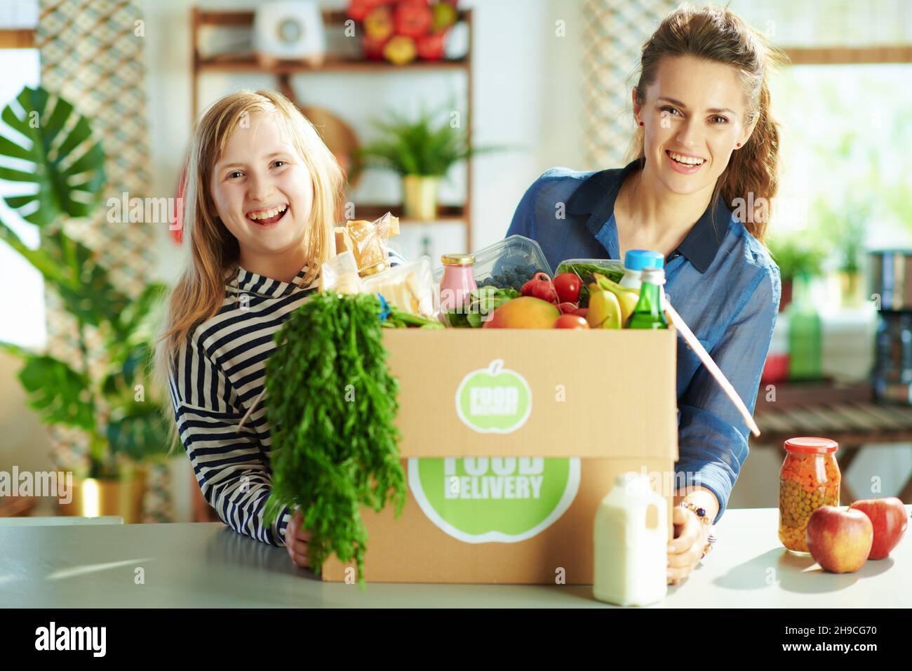 Food delivery. smiling young mother and daughter with food box in the