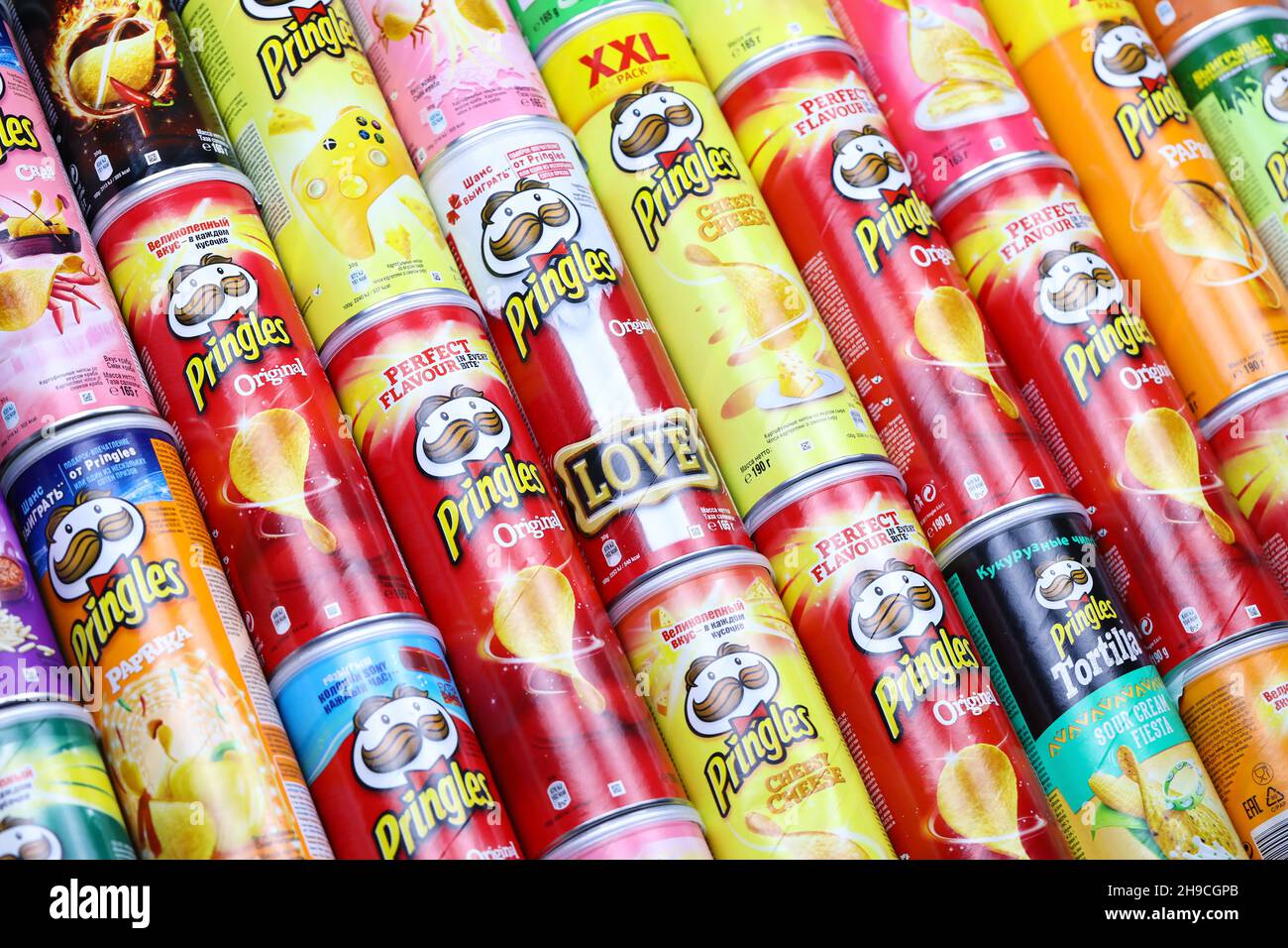 KHARKOV, UKRAINE - MARCH 30, 2021: Many Pringles cylinder chips boxes with varios colors and flavours. American brand of stackable potato-based crisps Stock Photo