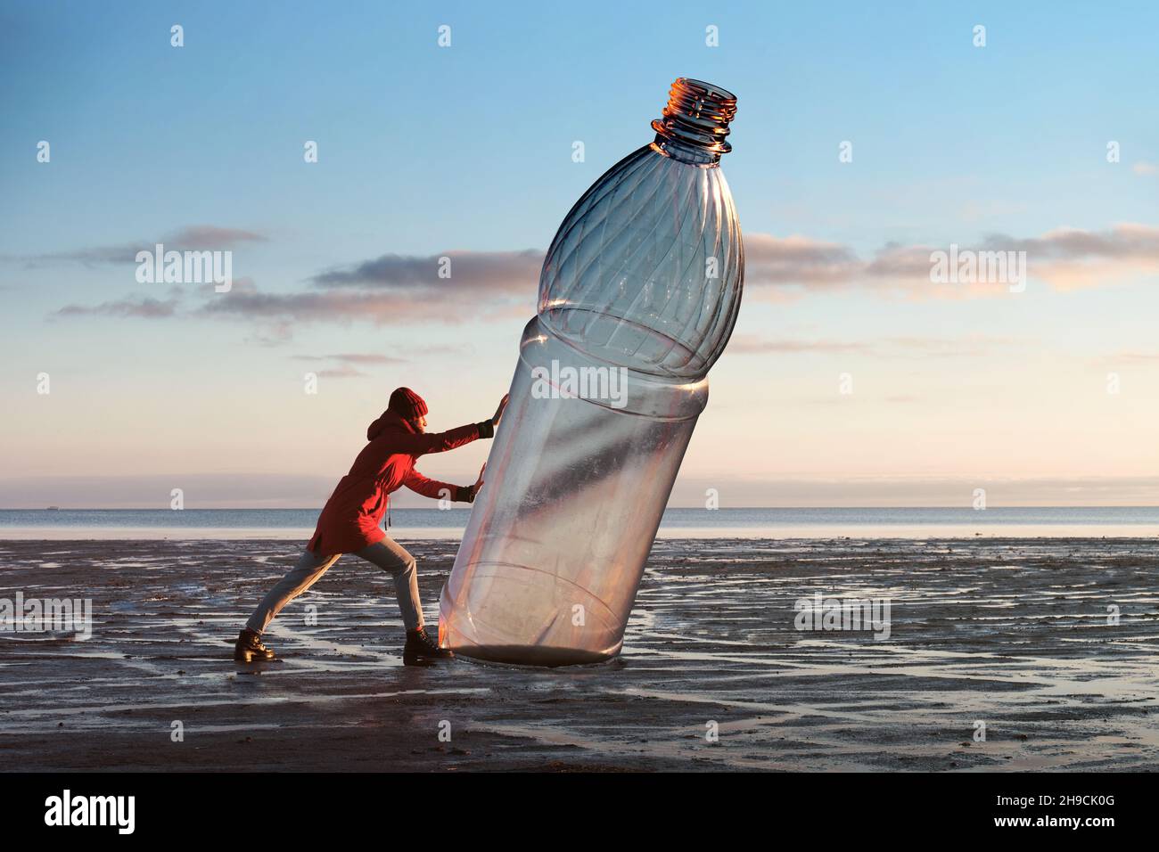 A Woman Is Pushing A Huge Plastic Bottle On The Shore Environmental Pollution By Plastic