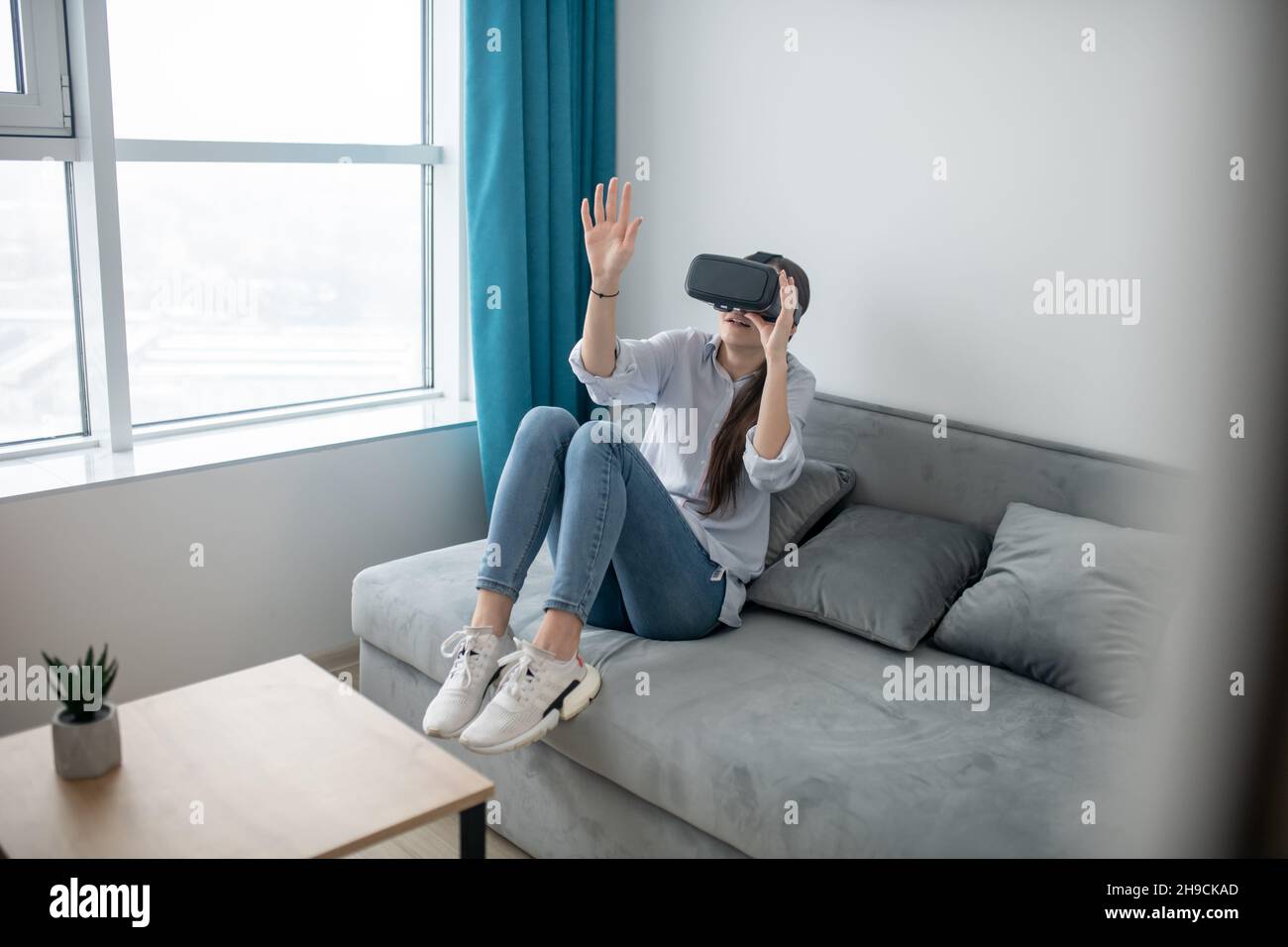 Caucasian female in VR goggles exploring virtual reality Stock Photo