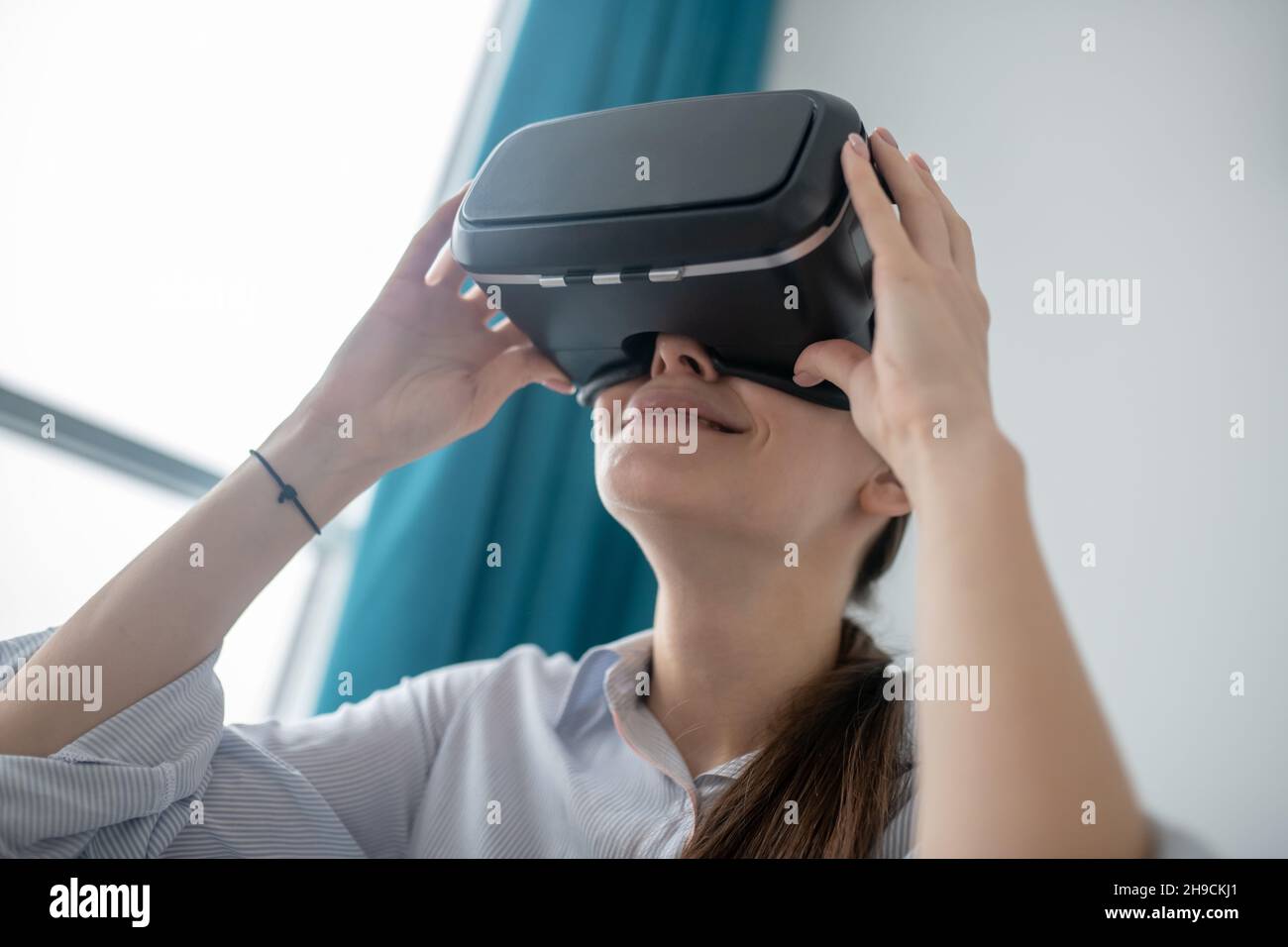 Woman using the wireless virtual reality headset Stock Photo