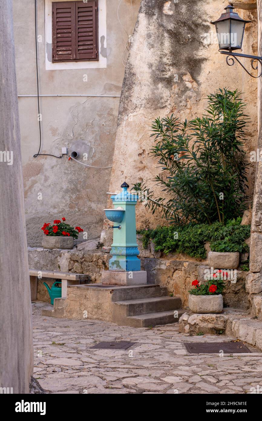 Blue antique water column with faucet. Old vintage water tap in Moscenice. Croatia. Stock Photo