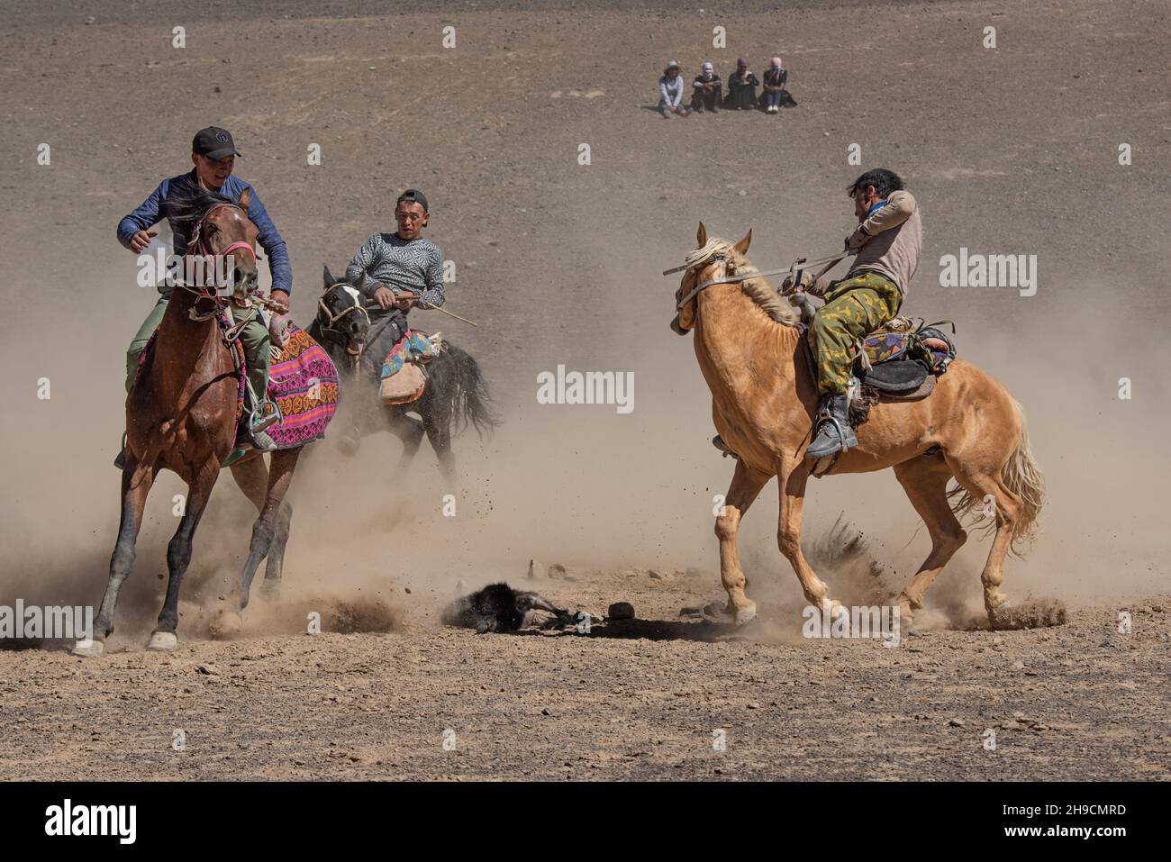 Horse riders competing in the traditional sport of 'ulak-tartysh-buzkashi' - goat polo at Murghab Horse festival, Tajikistan in August 2019 Stock Photo