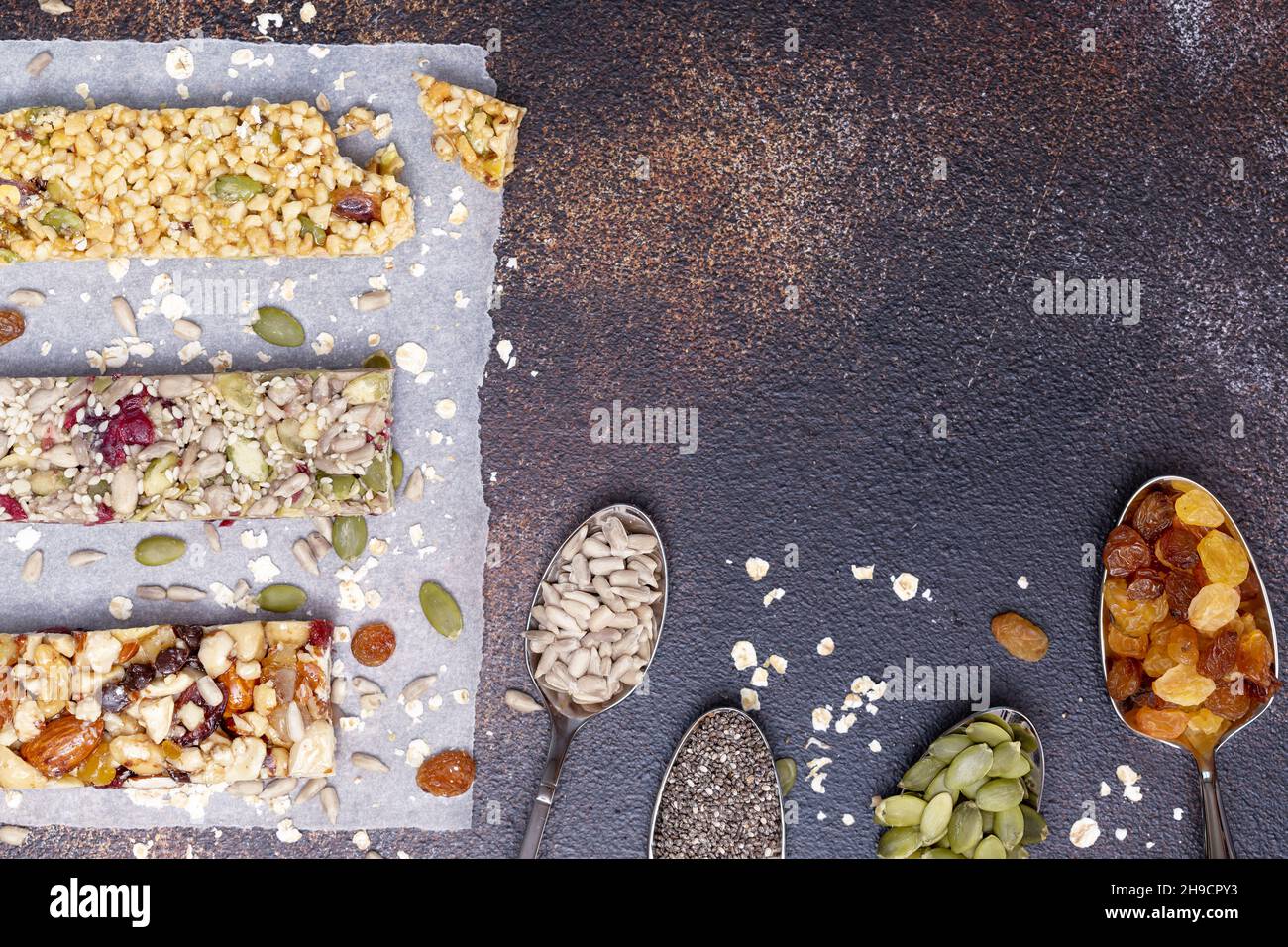 Different kind of granola cereal bars with nuts, seeds, oats, berries