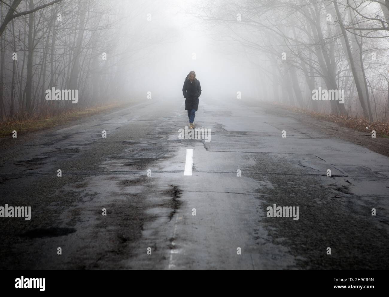 Woman walking in dark mysterious forest High Resolution Stock ...