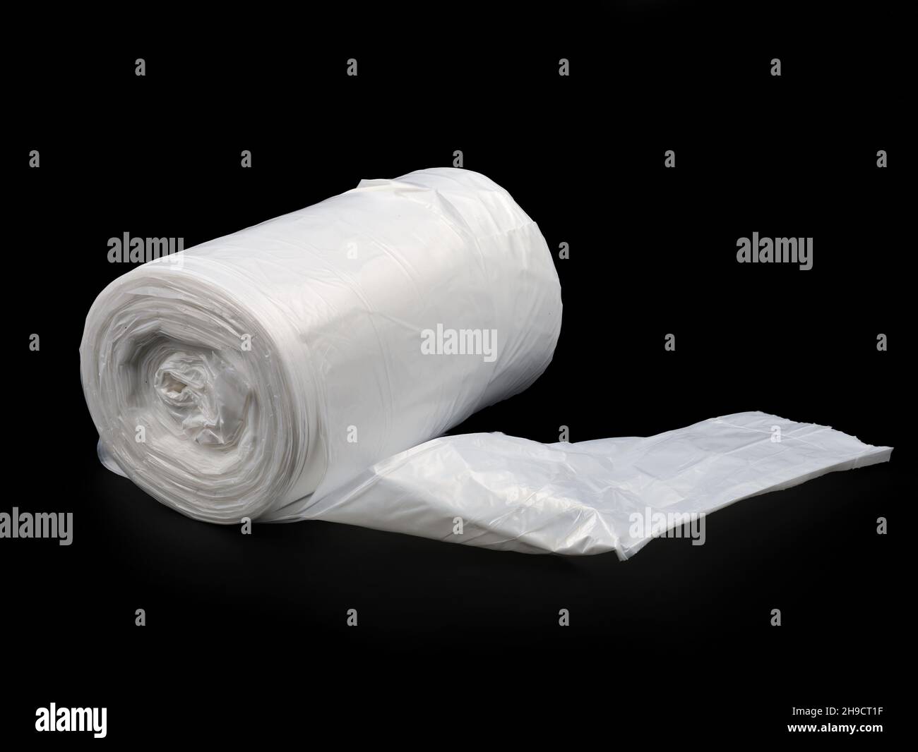 Traas Rol transparent plastic polyethylene trash bag roll isolated on black ...
