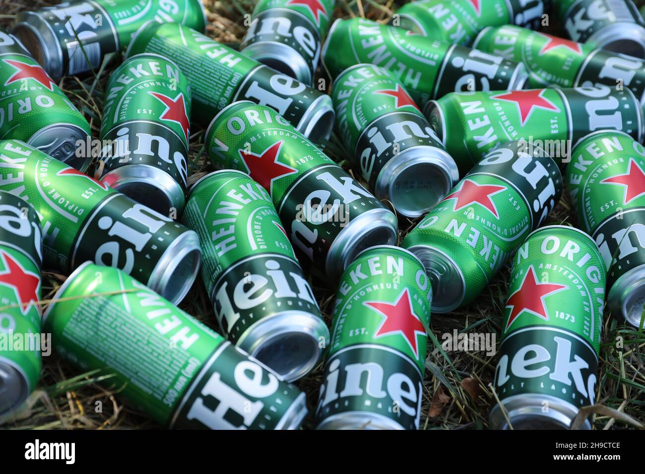 KHARKOV, UKRAINE - JULY 31, 2021: Green tin cans of Heineken pale lager beer produced by the Dutch brewing company Heineken N.V. Stock Photo