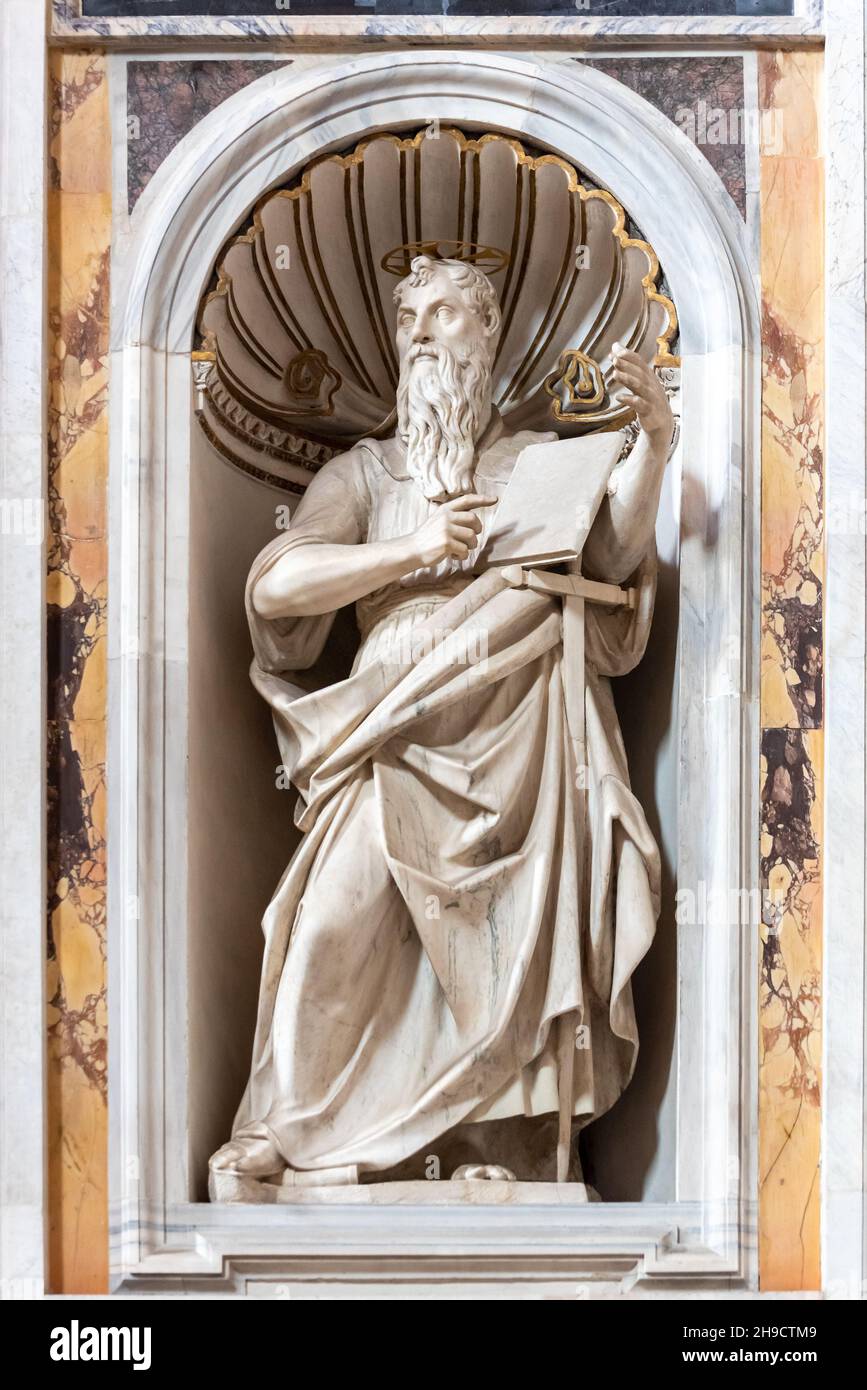 Close-up on marble statue of catholic saint decorating niche inside church in Rome Stock Photo