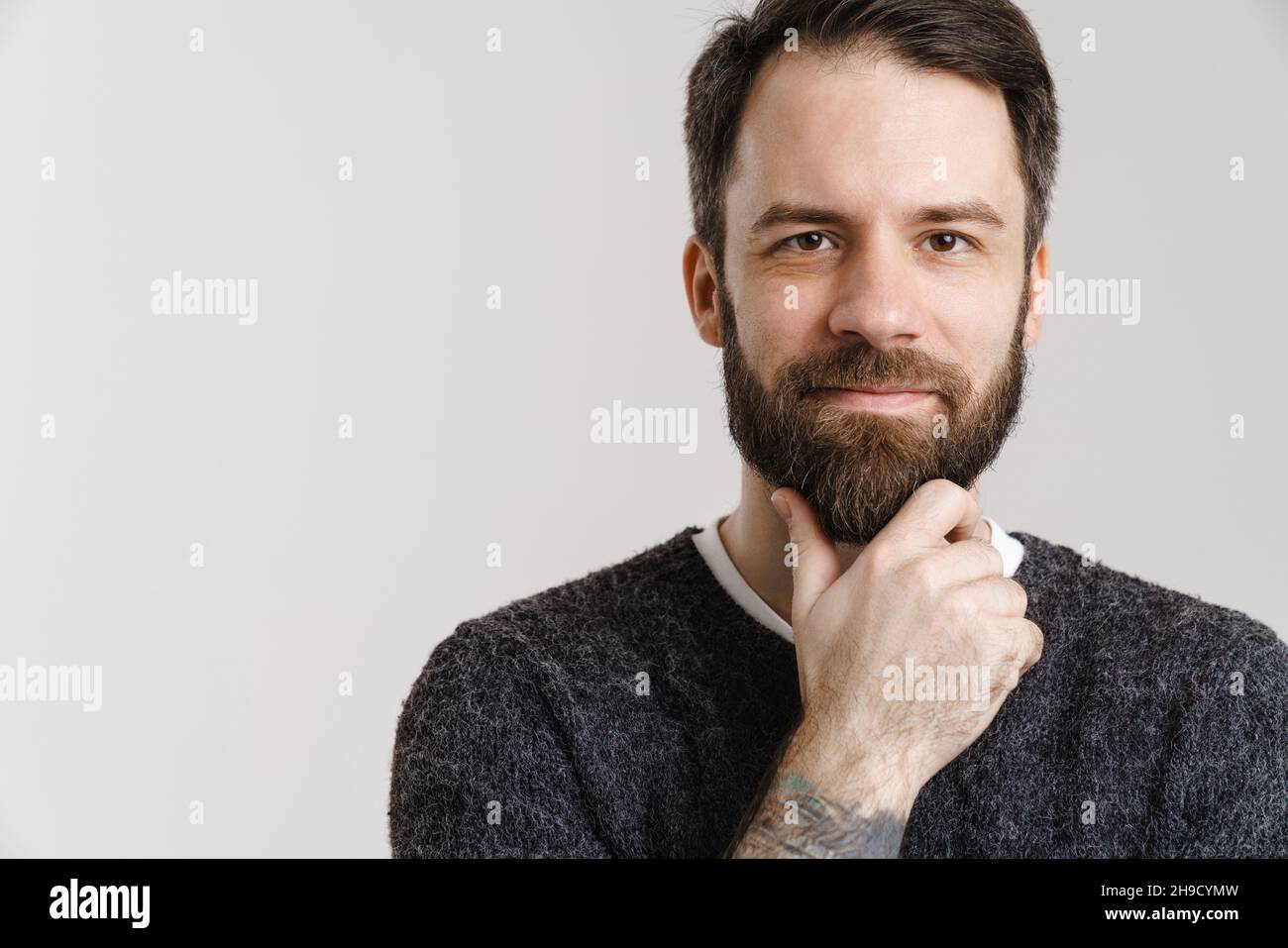 White mid man with beard posing and looking at camera isolated over ...