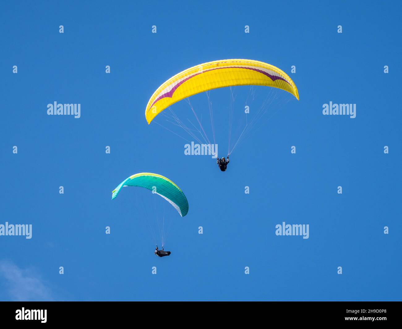 Paragliders fly from the Litlington White Horse, a monument in the Cuckmere Valley, East Sussex, England. Stock Photo