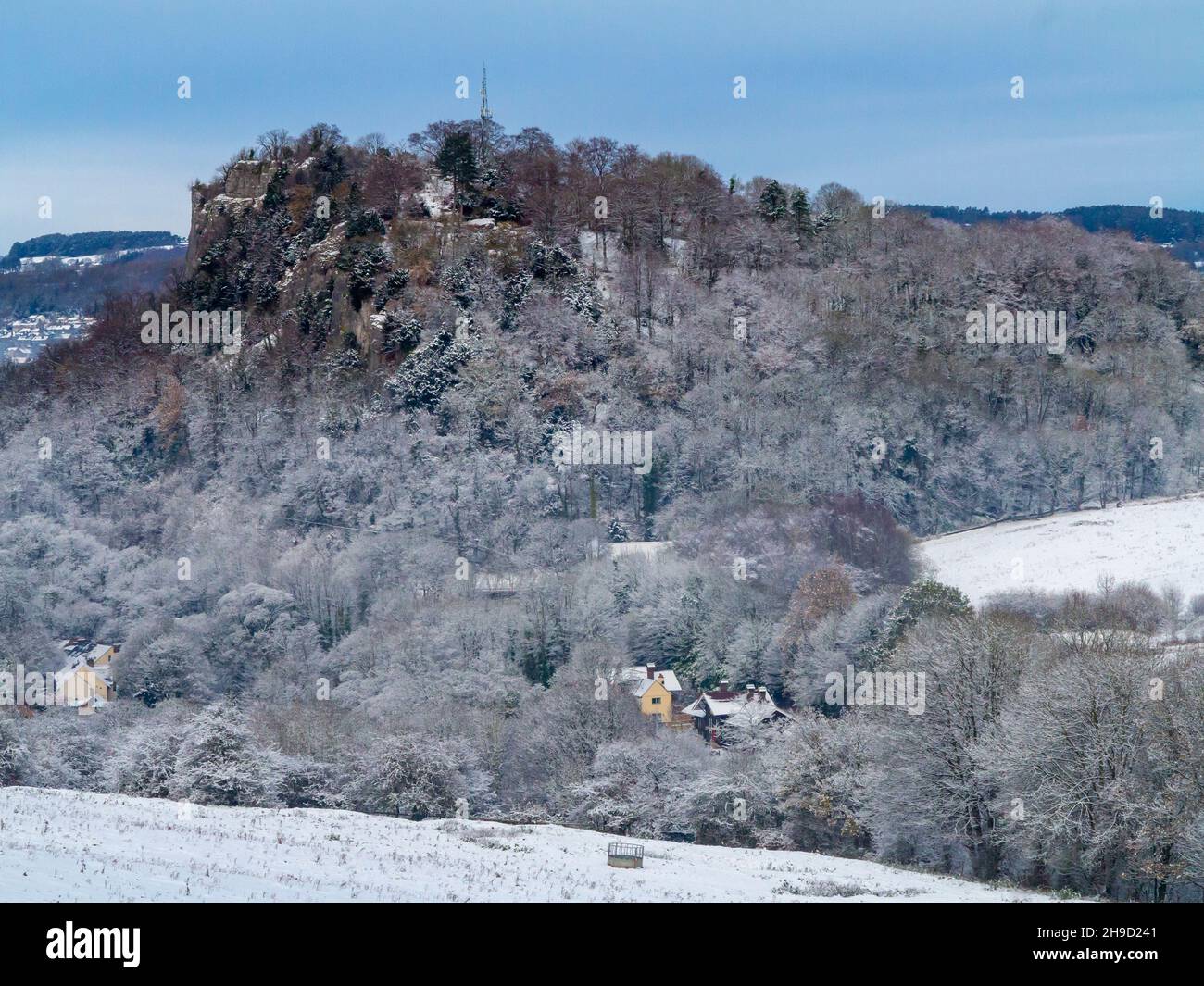 Snow covered landscape with trees at Matlock Bath in the Derbyshire Peak District England UK with High Tor visible in the distance. Stock Photo