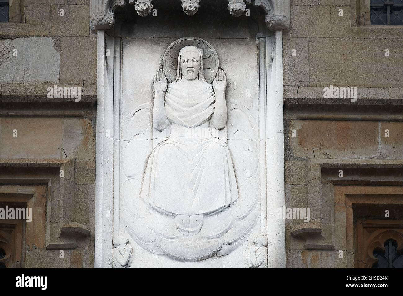 Stone sculpture on the facade of All Souls college, university of Oxford, England, of Jesus Christ seated in judgement of the dead. Stock Photo