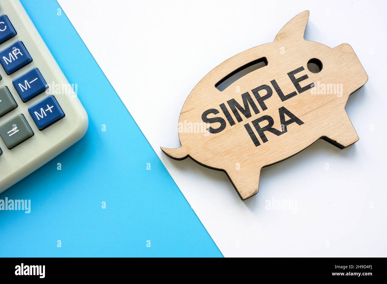 Wooden piggy bank with words SIMPLE IRA plans savings incentive match plans for employees. Stock Photo