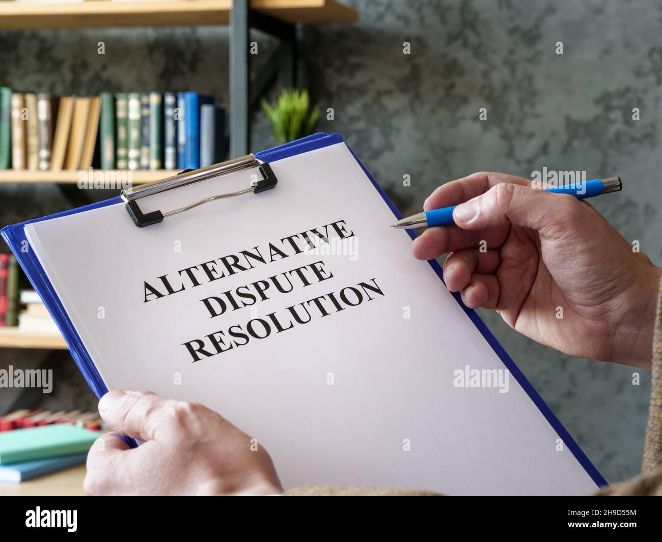 Man reads about alternative dispute resolution ADR. Stock Photo