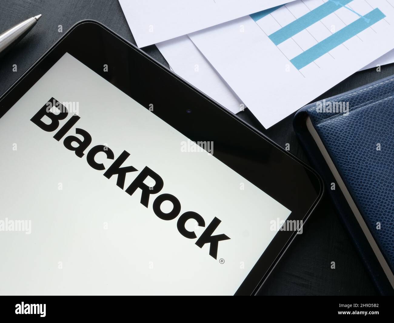 KYIV, UKRAINE - October 21, 2021. Tablet with BlackRock logo and papers. Stock Photo