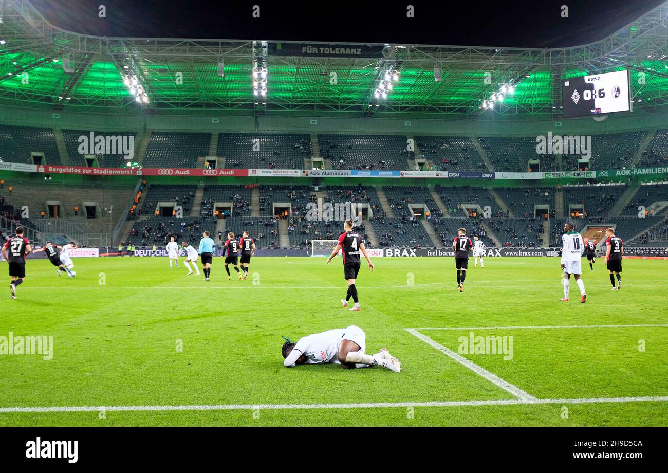 Kouadio KONE (MG) lies on the ground, in Borussia-Park, in the background the scoreboard with the result, final result 0: 6, action, football 1. Bundesliga, 14th matchday, Borussia Monchengladbach (MG) - SC Freiburg (FR) 0: 6, on December 5th, 2021 in Borussia Monchengladbach/Germany. #DFL regulations prohibit any use of photographs as image sequences and/or quasi-video # Â Stock Photo